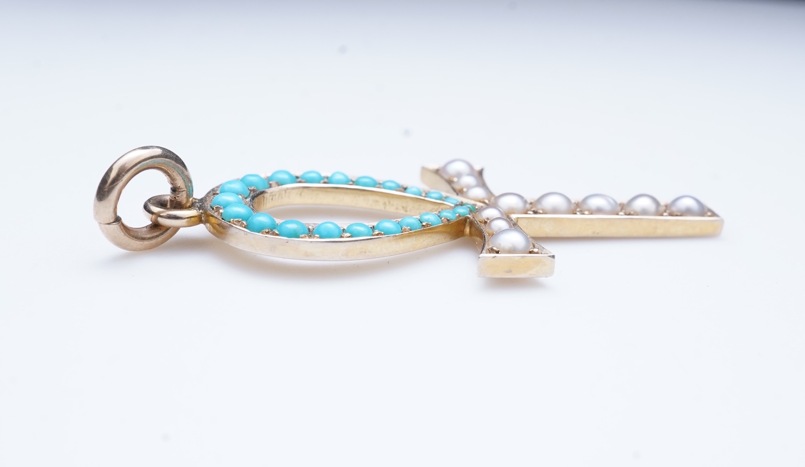 An Edwardian Egyptian revival turquoise and pearl pendant, early 20th century